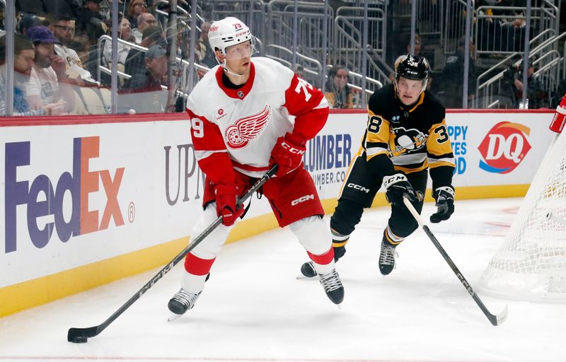 Oct 1, 2024; Pittsburgh, Pennsylvania, USA;  Detroit Red Wings forward Alex Chiasson (79) moves the puck ahed of Pittsburgh Penguins defenseman Owen Pickering (38) during the second period at PPG Paints Arena. Mandatory Credit: Charles LeClaire-Imagn Images