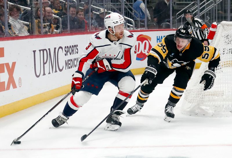 Jan 2, 2024; Pittsburgh, Pennsylvania, USA;  Washington Capitals defenseman Nick Jensen (3) moves the puck behind the net against pressure from Pittsburgh Penguins left wing Jake Guentzel (59) during the second period at PPG Paints Arena. Mandatory Credit: Charles LeClaire-USA TODAY Sports