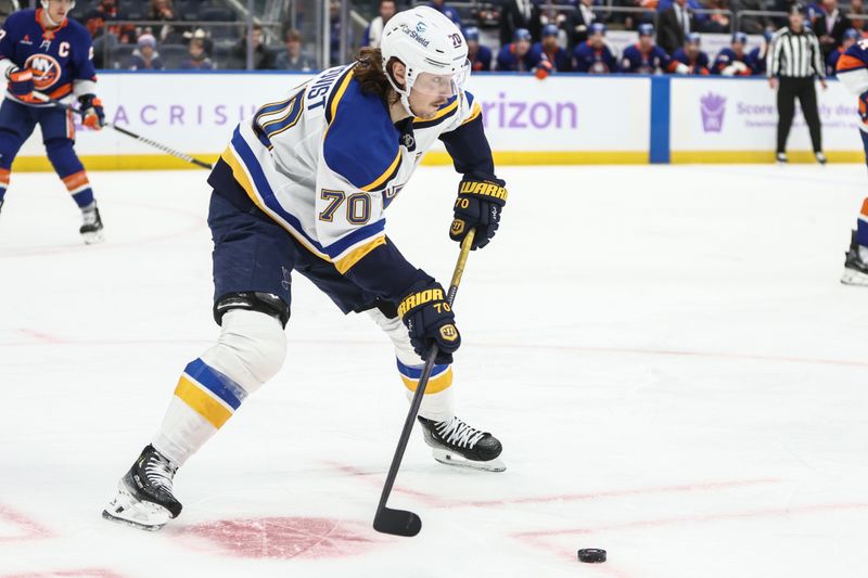 Nov 23, 2024; Elmont, New York, USA;  St. Louis Blues center Oskar Sundqvist (70) looks to make a pass in the third period against the New York Islanders at UBS Arena. Mandatory Credit: Wendell Cruz-Imagn Images