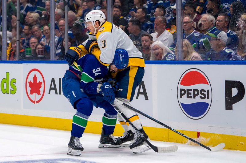 Apr 21, 2024; Vancouver, British Columbia, CAN; Nashville Predators defenseman Jeremy Lauzon (3) battles with Vancouver Canucks forward Phillip Di Giuseppe (34) in the first period in game one of the first round of the 2024 Stanley Cup Playoffs at Rogers Arena. Mandatory Credit: Bob Frid-USA TODAY Sports