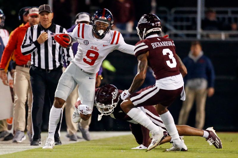 Nov 23, 2023; Starkville, Mississippi, USA; Mississippi Rebels wide receiver Tre Harris (9) runs after a catch as Mississippi State Bulldogs defensive backs Marcus Banks (1) and Decamerion Richardson (3) make the tackle during the first half at Davis Wade Stadium at Scott Field. Mandatory Credit: Petre Thomas-USA TODAY Sports