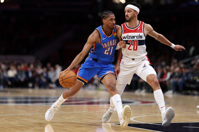 WASHINGTON, DC - JANUARY 08: Aaron Wiggins #21 of the Oklahoma City Thunder dribbles in front of Landry Shamet #20 of the Washington Wizards during the first half at Capital One Arena on January 08, 2024 in Washington, DC. NOTE TO USER: User expressly acknowledges and agrees that, by downloading and or using this photograph, User is consenting to the terms and conditions of the Getty Images License Agreement (Photo by Patrick Smith/Getty Images)