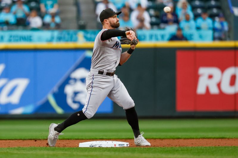 Jun 13, 2023; Seattle, Washington, USA; Miami Marlins shortstop Jon Berti (5) attempts to turn a double play against the Seattle Mariners during the second inning at T-Mobile Park. Mandatory Credit: Joe Nicholson-USA TODAY Sports