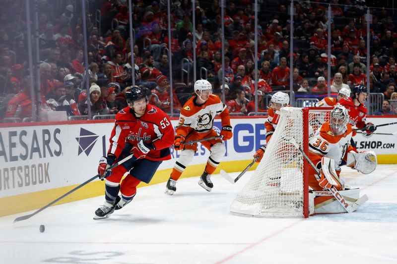 Jan 14, 2025; Washington, District of Columbia, USA; Washington Capitals center Ethen Frank (53) skates with the puck behind Anaheim Ducks goaltender John Gibson (36) in the third period at Capital One Arena. Mandatory Credit: Geoff Burke-Imagn Images