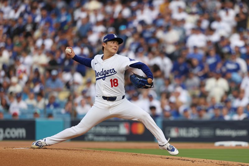 Oct 11, 2024; Los Angeles, California, USA; Los Angeles Dodgers pitcher Yoshinobu Yamamoto (18) pitches against the San Diego Padres in the first inning during game five of the NLDS for the 2024 MLB Playoffs at Dodger Stadium. Mandatory Credit: Kiyoshi Mio-Imagn Images