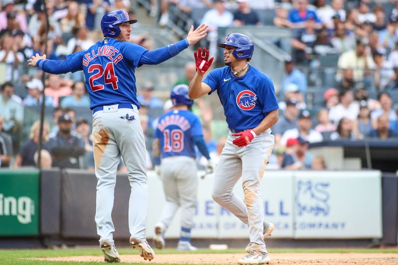 Jul 9, 2023; Bronx, New York, USA;  Chicago Cubs second baseman Christopher Morel (5) and center fielder Cody Bellinger (24) celebrate after tying the game in the seventh inning against the New York Yankees at Yankee Stadium. Mandatory Credit: Wendell Cruz-USA TODAY Sports