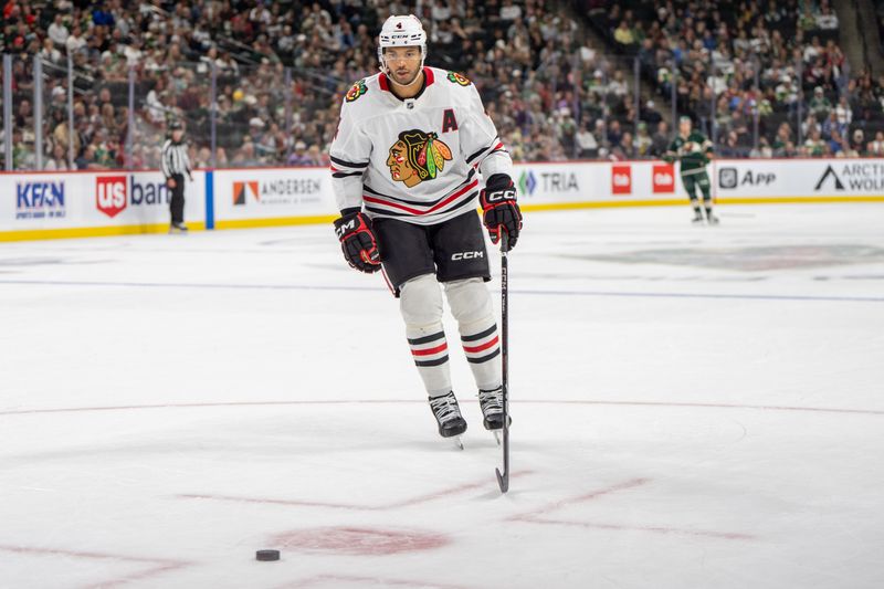 Oct 1, 2024; Saint Paul, Minnesota, USA; Chicago Blackhawks defenseman Seth Jones (4) chases a puck on a power play against the Minnesota Wild in the second period at Xcel Energy Center. Mandatory Credit: Matt Blewett-Imagn Images