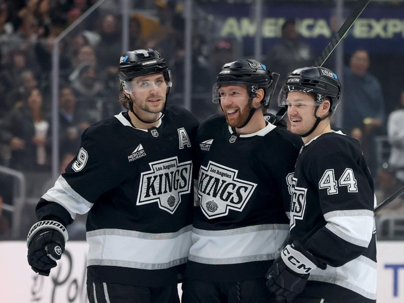 Nov 9, 2024; Los Angeles, California, USA; Los Angeles Kings defenseman Vladislav Gavrikov (84) celebrates with right wing Adrian Kempe (9) and defenseman Mikey Anderson (44) after scoring during the second period against the Columbus Blue Jackets at Crypto.com Arena. Mandatory Credit: Jason Parkhurst-Imagn Images