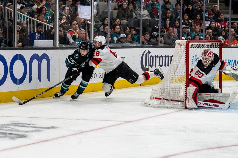 Feb 27, 2024; San Jose, California, USA;  San Jose Sharks left wing William Eklund (72) controls the puck against New Jersey Devils left wing Ondrej Palat (18) during the second period at SAP Center at San Jose. Mandatory Credit: Neville E. Guard-USA TODAY Sports