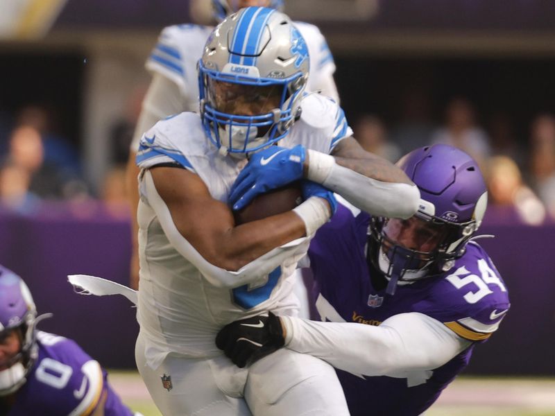 Detroit Lions running back David Montgomery (5) tries to break the tackle of Minnesota Vikings linebacker Kamu Grugier-Hill (54) during the second half of an NFL football game Sunday, Oct. 20, 2024, in Minneapolis. (AP Photo/Bruce Kluckhohn)