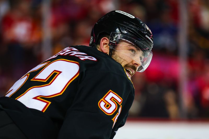 Dec 31, 2024; Calgary, Alberta, CAN; Calgary Flames defenseman MacKenzie Weegar (52) reacts against the Vancouver Canucks during the third period at Scotiabank Saddledome. Mandatory Credit: Sergei Belski-Imagn Images