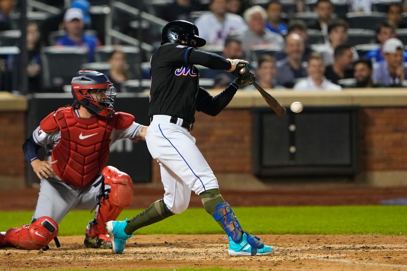 May 21, 2023; New York City, New York, USA; New York Mets shortstop Francisco Lindor (12) hits a single Cleveland Guardians second baseman Tyler Freeman (2) during the eighth inning at Citi Field. Mandatory Credit: Gregory Fisher-USA TODAY Sports