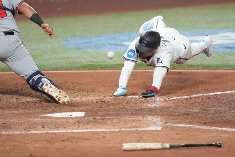 Sep 11, 2025; Miami, Florida, USA;  Miami Marlins center fielder Victor Mesa Jr. (10) scores a run in the eighth inning as Washington Nationals catcher Jorge Alfaro (44) gathers the late throw from the outfield at loanDepot Park. Mandatory Credit: Jim Rassol-Imagn Images