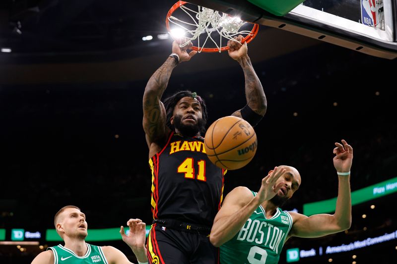 BOSTON, MA - FEBRUARY 7: Saddiq Bey #41 of the Atlanta Hawks dunks on Derrick White #9 of the Boston Celtics during the first quarter at TD Garden on February 7, 2024 in Boston, Massachusetts. NOTE TO USER: User expressly acknowledges and agrees that, by downloading and/or using this Photograph, user is consenting to the terms and conditions of the Getty Images License Agreement. (Photo By Winslow Townson/Getty Images)