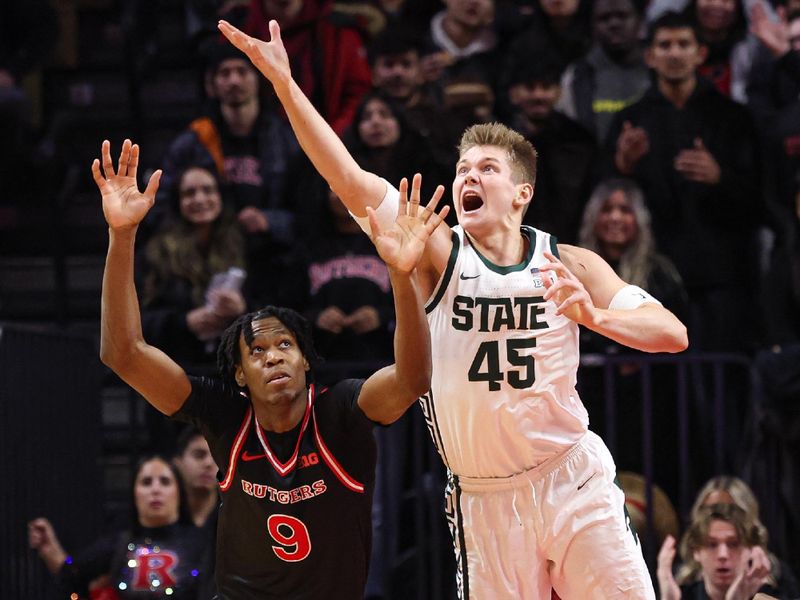 Jan 27, 2026; Piscataway, New Jersey, USA; Michigan State Spartans forward Jaxon Kohler (45) rebounds against Rutgers Scarlet Knights forward Dylan Grant (9) during the first half at Jersey Mike's Arena. Mandatory Credit: Vincent Carchietta-Imagn Images
