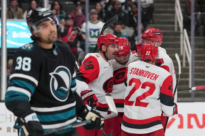 Oct 14, 2025; San Jose, California, USA;  Carolina Hurricanes center Logan Stankoven (22) celebrates with his teammates during the second period against the San Jose Sharks at SAP Center at San Jose. Mandatory Credit: Stan Szeto-Imagn Images