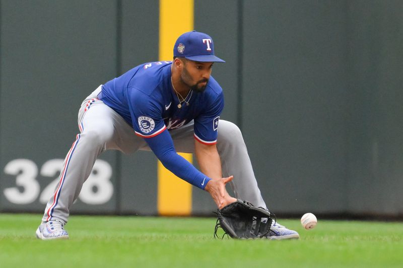 May 26, 2024; Minneapolis, Minnesota, USA;  Texas Rangers infielder Marcus Semien (2) fields a ground ball against the Minnesota Twins during the third inning at Target Field. Mandatory Credit: Nick Wosika-USA TODAY Sports