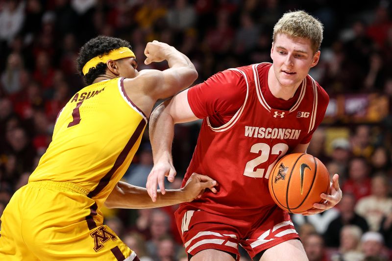 Mar 5, 2025; Minneapolis, Minnesota, USA; Wisconsin Badgers forward Steven Crowl (22) works around Minnesota Golden Gophers guard Isaac Asuma (1) during the second half at Williams Arena. Mandatory Credit: Matt Krohn-Imagn Images