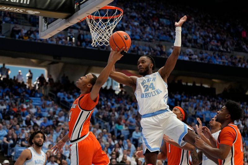 Jan 13, 2024; Chapel Hill, North Carolina, USA;  Syracuse Orange guard Quadir Copeland (24) shoots as North Carolina Tar Heels forward Jae'Lyn Withers (24) defends in the first half at Dean E. Smith Center. Mandatory Credit: Bob Donnan-USA TODAY Sports