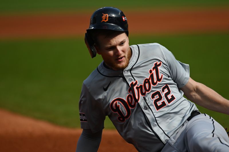 Oct 12, 2024; Cleveland, Ohio, USA; Detroit Tigers outfielder Parker Meadows (22) steals third base in the second inning against the Cleveland Guardians during game five of the ALDS for the 2024 MLB Playoffs at Progressive Field. Mandatory Credit: Ken Blaze-Imagn Images