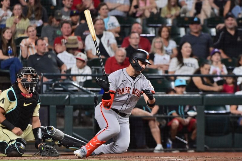 Jun 4, 2024; Phoenix, Arizona, USA;  San Francisco Giants outfielder Michael Conforto (8) hits a foul ball into his leg and falls in the sixth inning against the Arizona Diamondbacks at Chase Field. Mandatory Credit: Matt Kartozian-USA TODAY Sports