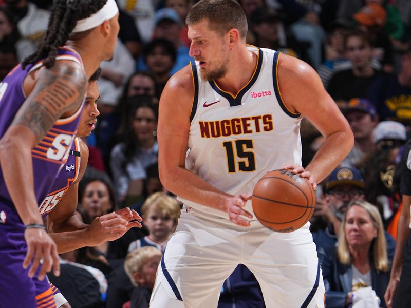 DENVER, CO - OCTOBER 13: Nikola Jokic #15 of the Denver Nuggets dribbles the ball during the game against the Phoenix Suns on October 13, 2024 at Ball Arena in Denver, Colorado. NOTE TO USER: User expressly acknowledges and agrees that, by downloading and/or using this Photograph, user is consenting to the terms and conditions of the Getty Images License Agreement. Mandatory Copyright Notice: Copyright 2024 NBAE (Photo by Garrett Ellwood/NBAE via Getty Images)