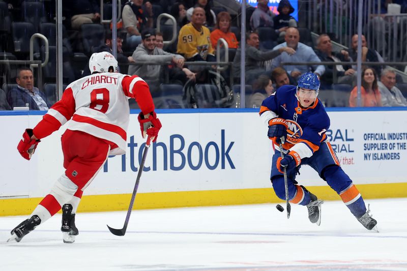 Oct 22, 2024; Elmont, New York, USA; New York Islanders right wing Maxim Tsyplakov (7) plays the puck against Detroit Red Wings defenseman Ben Chiarot (8) during the second period at UBS Arena. Mandatory Credit: Brad Penner-Imagn Images