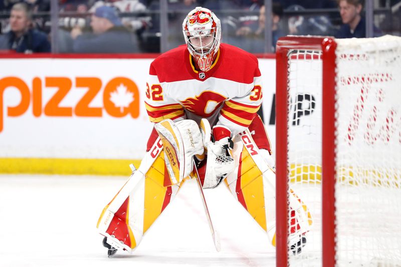 Apr 4, 2024; Winnipeg, Manitoba, CAN; Calgary Flames goaltender Dustin Wolf (32) looks on in the second period against the Winnipeg Jets at Canada Life Centre. Mandatory Credit: James Carey Lauder-USA TODAY Sports