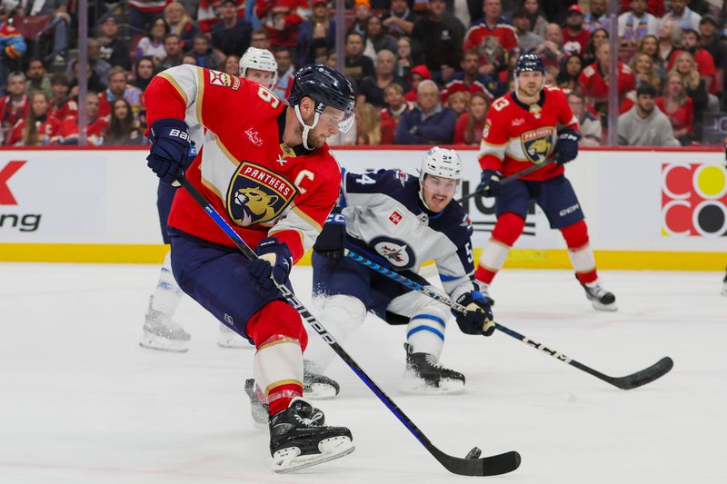 Nov 24, 2023; Sunrise, Florida, USA; Florida Panthers center Aleksander Barkov (16) moves the puck against the Winnipeg Jets during the second period at Amerant Bank Arena. Mandatory Credit: Sam Navarro-USA TODAY Sports