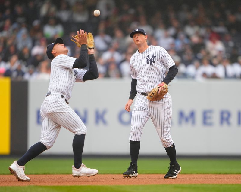 Apr 5, 2023; Bronx, New York, USA; New York Yankees shortstop Anthony Volpe (11) catches a fly ball hit by Philadelphia Phillies catcher J.T. Realmuto (10) (not pictured) during the first inning at Yankee Stadium. Mandatory Credit: Gregory Fisher-USA TODAY Sports