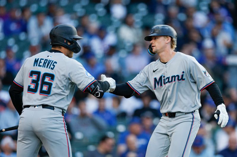 May 14, 2025; Chicago, Illinois, USA; Miami Marlins center fielder Kyle Stowers (28) celebrates with first baseman Matt Mervis (36) after hitting a solo home run against the Chicago Cubs during the second inning at Wrigley Field. Mandatory Credit: Kamil Krzaczynski-Imagn Images