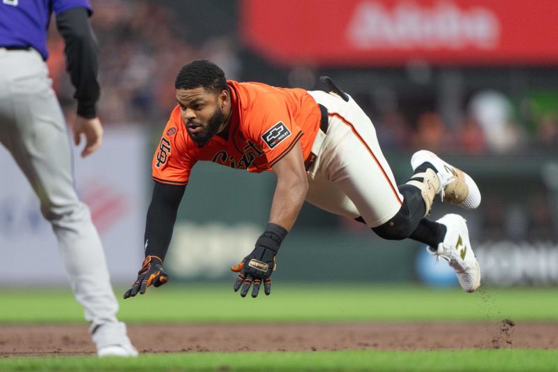 Jul 26, 2024; San Francisco, California, USA;  San Francisco Giants outfielder Heliot Ramos (17) dives at third base after hitting a triple during the third inning against the Colorado Rockies at Oracle Park. Mandatory Credit: Stan Szeto-USA TODAY Sports