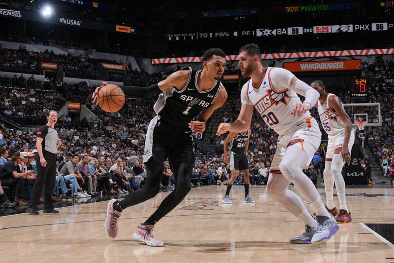 SAN ANTONIO, TX - MARCH 23:  Victor Wembanyama #1 of the San Antonio Spurs handles the ball during the game against the Phoenix Suns on March 23, 2024 at the Frost Bank Center in San Antonio, Texas. NOTE TO USER: User expressly acknowledges and agrees that, by downloading and or using this photograph, user is consenting to the terms and conditions of the Getty Images License Agreement. Mandatory Copyright Notice: Copyright 2024 NBAE (Photos by Jesse D. Garrabrant/NBAE via Getty Images)