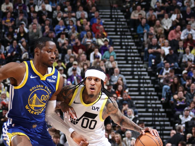 SALT LAKE CITY, UT - FEBRUARY 15: Jordan Clarkson #00 of the Utah Jazz drives to the basket against Jonathan Kuminga #00 of the Golden State Warriors during the game on February 15, 2024 at Delta Center in Salt Lake City, Utah. NOTE TO USER: User expressly acknowledges and agrees that, by downloading and or using this Photograph, User is consenting to the terms and conditions of the Getty Images License Agreement. Mandatory Copyright Notice: Copyright 2024 NBAE (Photo by Melissa Majchrzak/NBAE via Getty Images)