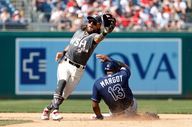 Apr 5, 2023; Washington, District of Columbia, USA; Tampa Bay Rays right fielder Manuel Margot (13) steals second base ahead of a throw to Washington Nationals first baseman Michael Chavis (6) during the sixth inning at Nationals Park. Mandatory Credit: Geoff Burke-USA TODAY Sports