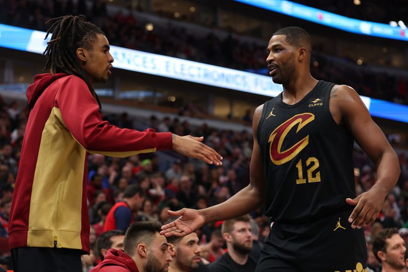 CHICAGO, ILLINOIS - DECEMBER 23: Tristan Thompson #12 of the Cleveland Cavaliers high fives Emoni Bates #21 against the Chicago Bulls during the first half at the United Center on December 23, 2023 in Chicago, Illinois. NOTE TO USER: User expressly acknowledges and agrees that, by downloading and or using this photograph, User is consenting to the terms and conditions of the Getty Images License Agreement.  (Photo by Michael Reaves/Getty Images)