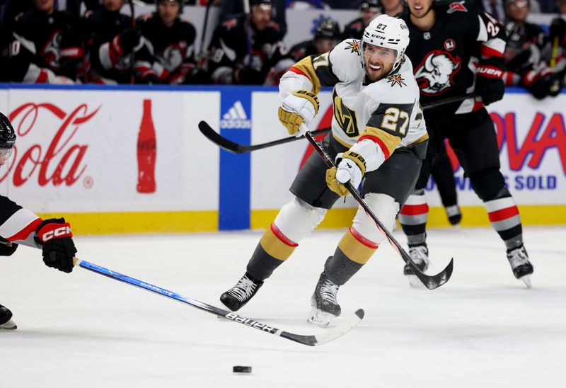 Mar 2, 2024; Buffalo, New York, USA;  Vegas Golden Knights defenseman Shea Theodore (27) takes a shot on goal during the first period against the Buffalo Sabres at KeyBank Center. Mandatory Credit: Timothy T. Ludwig-USA TODAY Sports