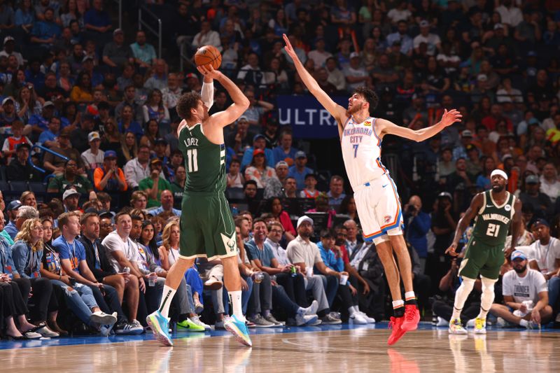 OKLAHOMA CITY, OK - APRIL 12: Brook Lopez #11 of the Milwaukee Bucks shoots the ball while Chet Holmgren #7 of the Oklahoma City Thunder goes up for the block during the game on April 12, 2024 at Paycom Arena in Oklahoma City, Oklahoma. NOTE TO USER: User expressly acknowledges and agrees that, by downloading and or using this photograph, User is consenting to the terms and conditions of the Getty Images License Agreement. Mandatory Copyright Notice: Copyright 2024 NBAE (Photo by Zach Beeker/NBAE via Getty Images)