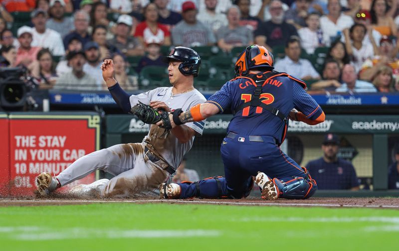 Aug 19, 2024; Houston, Texas, USA; Boston Red Sox left fielder Rob Refsnyder (30) is tagged out by Houston Astros catcher Victor Caratini (17) on a play at the plate during the first inning at Minute Maid Park. Mandatory Credit: Troy Taormina-USA TODAY Sports