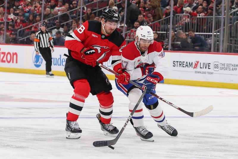 Nov 6, 2025; Newark, New Jersey, USA; New Jersey Devils right wing Timo Meier (28) and Montreal Canadiens defenseman Jayden Struble (47) battle for the puck during the second period at Prudential Center. Mandatory Credit: Ed Mulholland-Imagn Images
