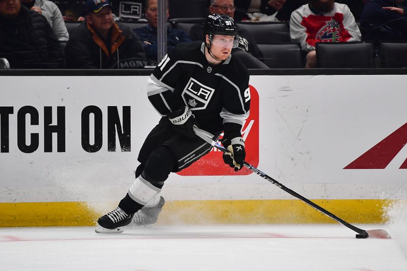 Mar 16, 2023; Los Angeles, California, USA; Los Angeles Kings right wing Carl Grundstrom (91) moves the puck against the Columbus Blue Jackets during the second period at Crypto.com Arena. Mandatory Credit: Gary A. Vasquez-USA TODAY Sports