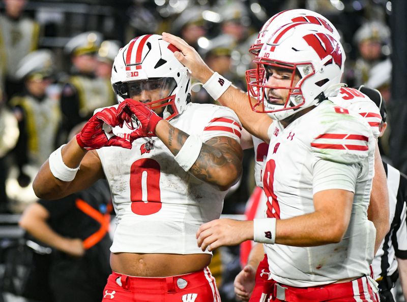 Sep 22, 2023; West Lafayette, Indiana, USA;  Wisconsin Badgers running back Braelon Allen (0) makes a heart with his hands in honor of teammate Wisconsin Badgers running back Chez Mellusi (1) after Mellusi suffered an injury during the second half at Ross-Ade Stadium. Mandatory Credit: Robert Goddin-USA TODAY Sports