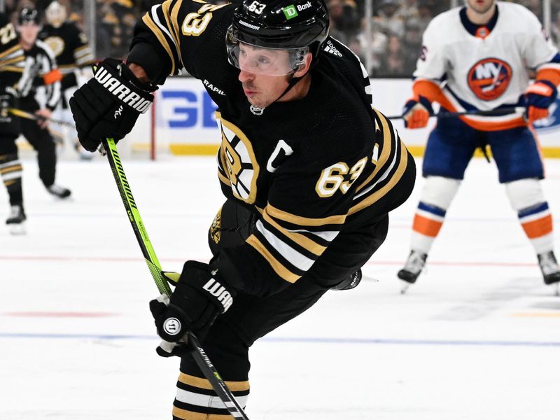 Nov 9, 2023; Boston, Massachusetts, USA; Boston Bruins left wing Brad Marchand (63) takes a shot against the New York Islanders during the third period at the TD Garden. Mandatory Credit: Brian Fluharty-USA TODAY Sports