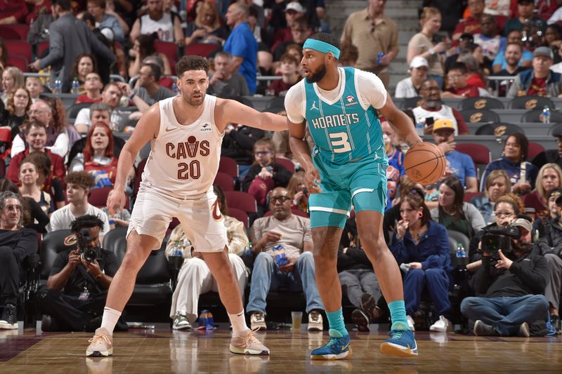 CLEVELAND, OH - APRIL 14: Georges Niang #20 of the Cleveland Cavaliers plays defense against Marques Bolden #3 of the Charlotte Hornets on April 14, 2024 at Rocket Mortgage FieldHouse in Cleveland, Ohio. NOTE TO USER: User expressly acknowledges and agrees that, by downloading and/or using this Photograph, user is consenting to the terms and conditions of the Getty Images License Agreement. Mandatory Copyright Notice: Copyright 2024 NBAE (Photo by David Liam Kyle/NBAE via Getty Images)