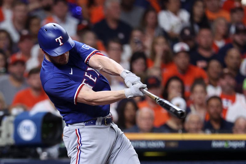 Oct 22, 2023; Houston, Texas, USA; Texas Rangers catcher Mitch Garver (18) hits a home run against the Houston Astros in the second inning during game six of the ALCS for the 2023 MLB playoffs at Minute Maid Park. Mandatory Credit: Troy Taormina-USA TODAY Sports