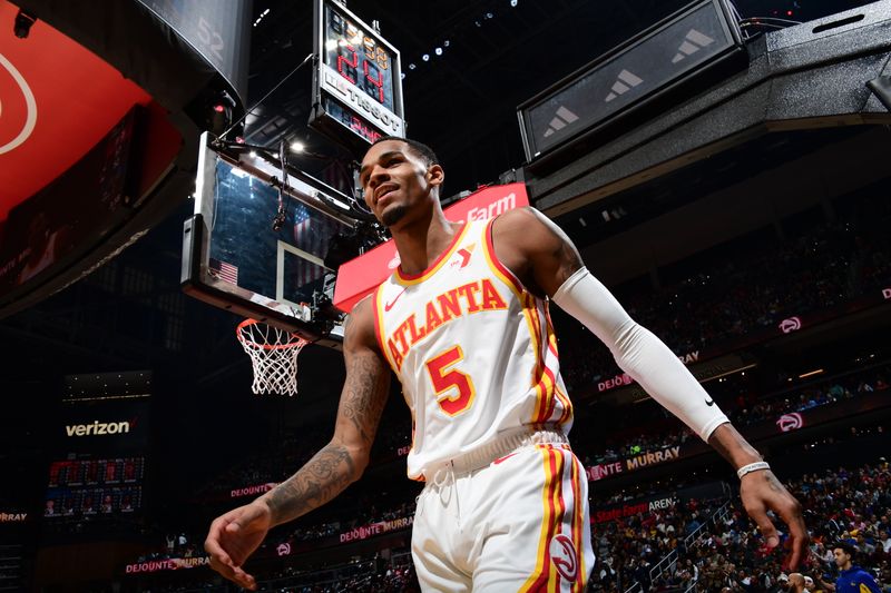 ATLANTA, GA - FEBRUARY 3: Dejounte Murray #5 of the Atlanta Hawks smiles during the game against the Golden State Warriors on February 3, 2024 at State Farm Arena in Atlanta, Georgia.  NOTE TO USER: User expressly acknowledges and agrees that, by downloading and/or using this Photograph, user is consenting to the terms and conditions of the Getty Images License Agreement. Mandatory Copyright Notice: Copyright 2024 NBAE (Photo by Scott Cunningham/NBAE via Getty Images)