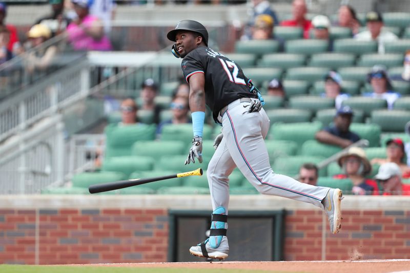 Aug 4, 2024; Cumberland, Georgia, USA; Miami Marlins right fielder Jesus Sanchez (12) hits a fly ball against Atlanta Braves in the first inning at Truist Park. Mandatory Credit: Mady Mertens-USA TODAY Sports