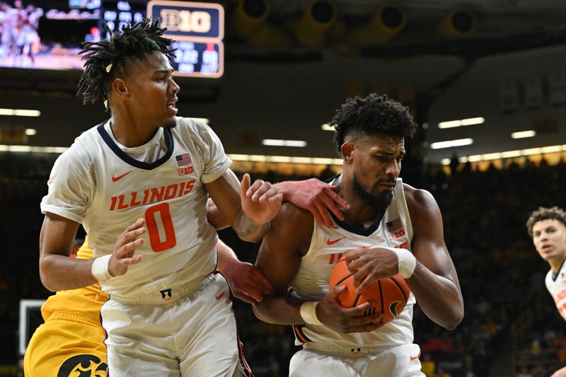 Mar 10, 2024; Iowa City, Iowa, USA; Illinois Fighting Illini guard Terrence Shannon Jr. (0) and forward Quincy Guerrier (13) grab a rebound against the Iowa Hawkeyes during the second half at Carver-Hawkeye Arena. Mandatory Credit: Jeffrey Becker-USA TODAY Sports