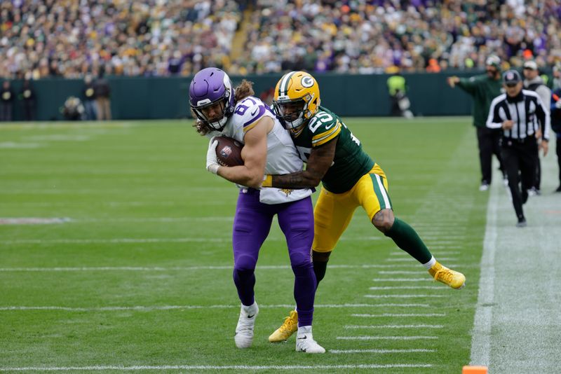 Minnesota Vikings tight end T.J. Hockenson (87) tries to elude Green Bay Packers cornerback Keisean Nixon (25) during an NFL football game Sunday, Oct. 29, 2023, in Green Bay, Wis. (AP Photo/Mike Roemer)