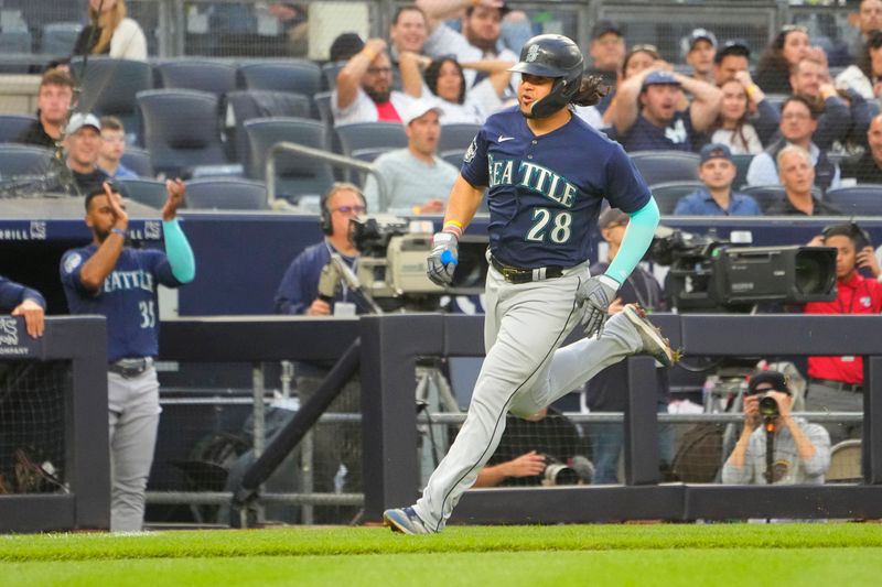 Jun 22, 2023; Bronx, New York, USA; Seattle Mariners third baseman Eugenio Suarez (28) scores a run on an error  during the third inning against the New York Yankees at Yankee Stadium. Mandatory Credit: Gregory Fisher-USA TODAY Sports